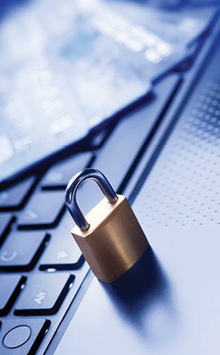 Locked padlock and four credit cards on blue computer keyboard  E-commerce data and ebanking protection, internet and finance security concept 