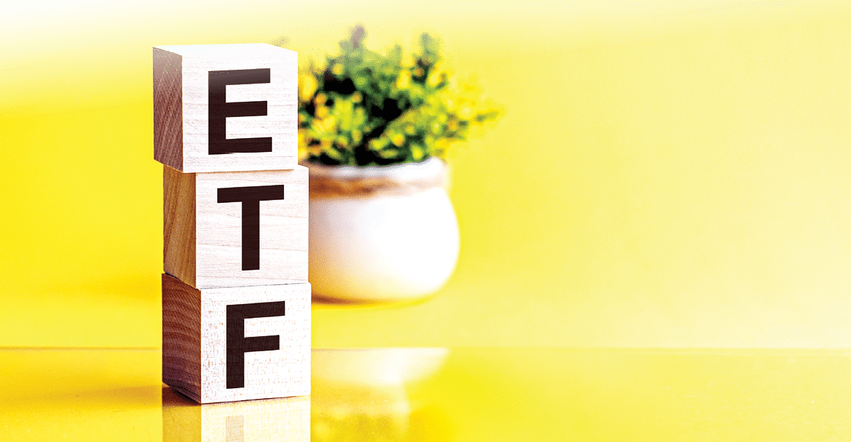 ETF word made of wooden cubes on a yellow background with copy space, business concept