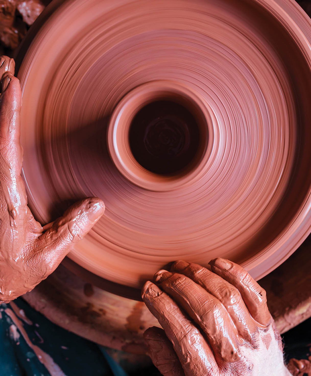 Professional potter making bowl in pottery workshop, studio 